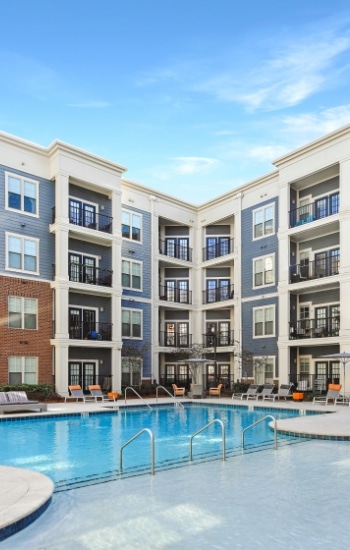 4-story modern apartment buildings surrounding a pool